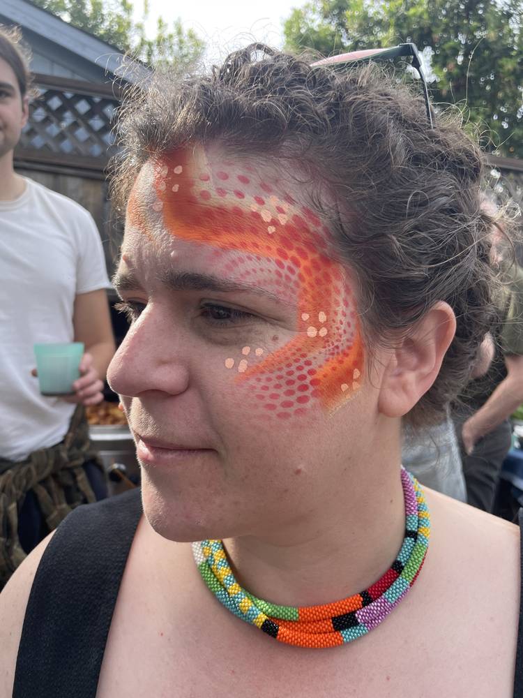Orange koi swirl face paint