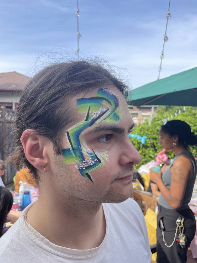 Teal lightning bolt face paint